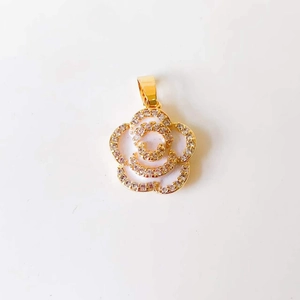 Detail of camellia flower pendant with gold plating, rhinestones and enamel petals