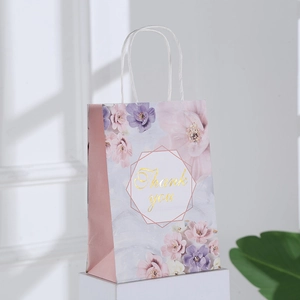Elegant floral kraft paper gift bag with golden Thank You text and white rope handles