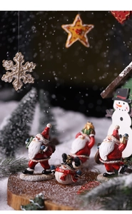 Detailed resin Christmas figurines with Santa Claus and snowman on snowy wood base