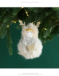 Plush reindeer angel ornament hanging on a Christmas tree with warm bokeh lighting