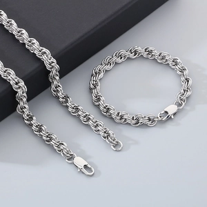 Detailed view of silver stainless steel twisted chain necklace and bracelet set with lobster clasp