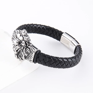 Men's woven black leather bracelet featuring a silver lion head charm and magnetic clasp
