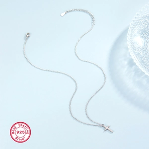 Detailed macro view of S925 sterling silver cross pendant necklace with sparkling stones