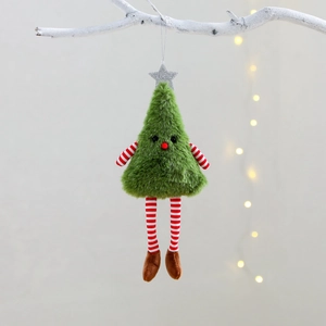 Green plush Christmas tree ornament with long striped legs hanging on a white branch