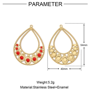 Detailed view of teardrop hollow earrings with red enamel in gold plated stainless steel