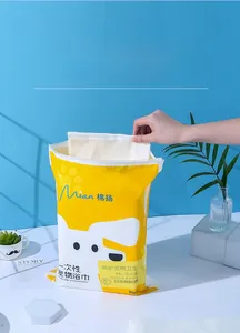 Detail showing hand extracting a 60x120cm thick absorbent disposable pet bath towel
