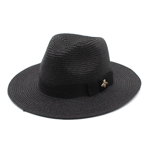 Men's black straw Panama hat with a black satin ribbon and gold bee metal logo emblem