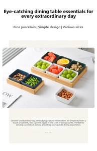 Detail of square ceramic snack bowls in white and green on a natural bamboo tray