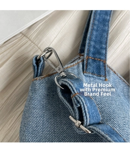 Detail of silver swivel hook and orange stitching on a blue denim bucket bag strap