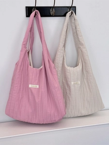 Minimalist pleated fabric tote bags in pink and beige with wide shoulder straps