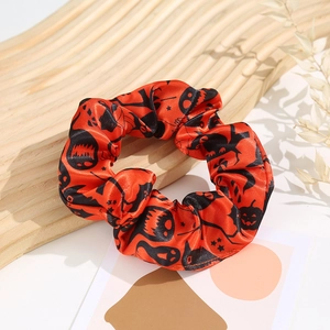 Halloween silk scrunchie with pumpkin and ghost patterns on red and black satin