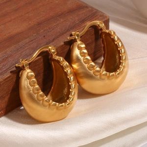Detailed view of chunky 18K gold plated hoop earrings with inner beaded texture on silk