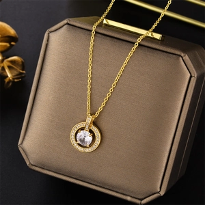 Close-up of a luxury gold circle pendant with zircon stones on a vintage jewelry box