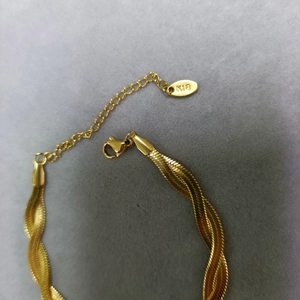 Double layered 18K gold snake chain bracelet with elegant intertwined texture and K18 tag