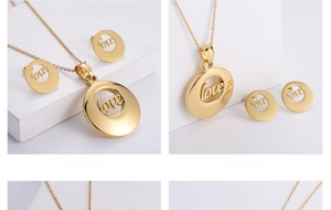 Detail of gold-plated hollow LOVE necklace and earrings set on minimalist white stands