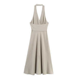 Detail of waist tie and halter neck design on beige backless dress for women