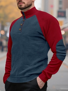 Detail of navy and red ribbed knit shirt featuring a buttoned Henley collar