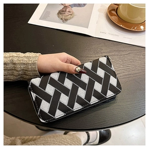 Detail of woven texture long wallet featuring a grey and black checkered pattern design
