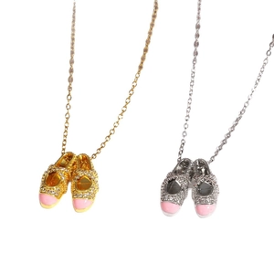 Elegant gold and silver baby shoe necklaces with pink enamel and diamond accents