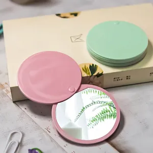Portable folding round makeup mirrors in pink and mint green with matte finish case