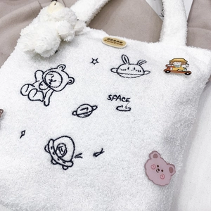 White plush astronaut tote bag with cute space-themed embroidery and soft texture
