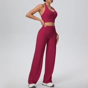 Detail view of burgundy two-piece yoga set showing halter sports top and high waist pants