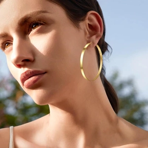 Classic large gold plated S925 sterling silver hoop earrings for women in outdoor setting