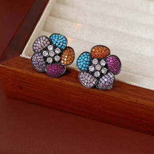 Detail of vintage flower earrings with colorful zircon stones on a luxury jewelry box