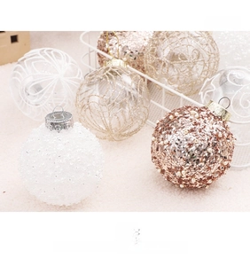 Detail of 8cm transparent Christmas baubles with white sequins and gold geometric patterns