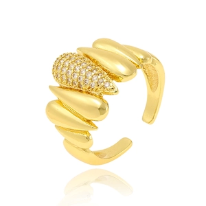 Adjustable golden feather ring with sparkling pavé cubic zirconia on white background