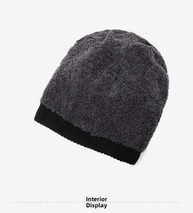 Detail view of the thick grey plush lining and black knitted edge of the winter hat