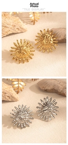 Macro shot of sunburst stud earrings with hammered metal texture in gold and silver