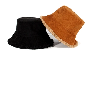 Detailed texture of corduroy exterior and fluffy sherpa lining on winter bucket hats