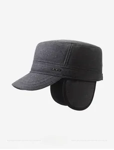 Detail view of the gray woolen fabric texture and metal logo badge on this winter cap
