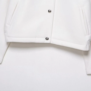 White soft bomber jacket with metallic silver buttons and premium textured fabric detail