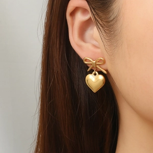 Golden bow stud earrings with heart pendants made of 18K gold-plated stainless steel