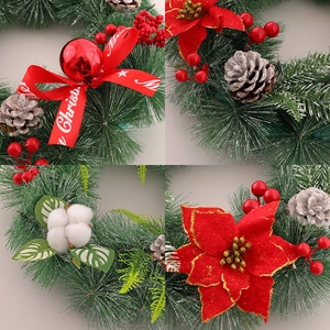 Christmas wreath with snowy pine needles, red poinsettia, pine cones and berries decoration