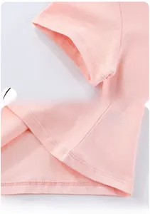 Detail of pink cotton T-shirt showing sleeve cuffs and hem stitching craftsmanship