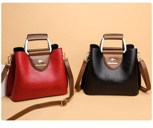 Polished PU leather tote bags in red and black with brown handles and metal logo detail