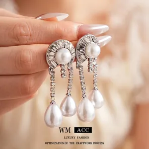 Elegant silver-tone pearl drop earrings with sparkling rhinestones and dangling crystal chains