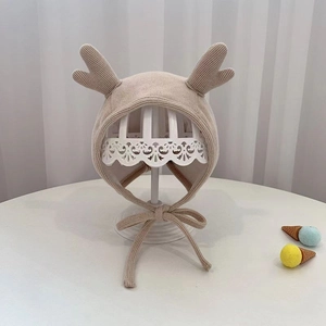 Cute beige infant knit earflap hat with deer antlers for autumn and winter warmth
