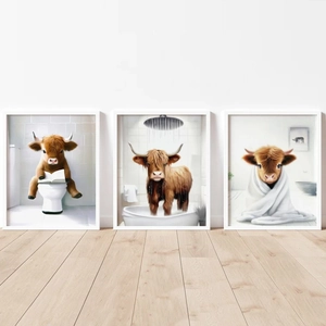 Three framed canvas prints showing funny Highland cows in bathroom scenes on white wall