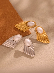 Detail of 18K gold and silver plated ferris wheel earrings with inlaid pearls