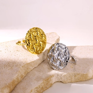 Detailed close-up of woven texture on adjustable gold and silver rings over stone