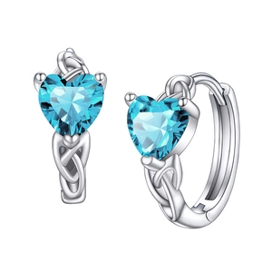 Detailed macro view of heart-shaped blue gems in silver Celtic knot earring settings