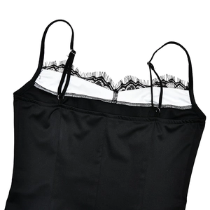 Detailed view of black lace trim on a low-cut neckline of a sleek bodycon dress