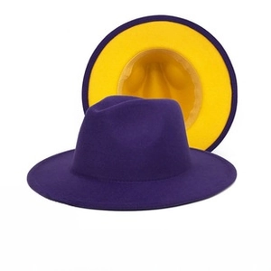 Detail of wool fedora hat featuring a contrast design with purple exterior and yellow interior