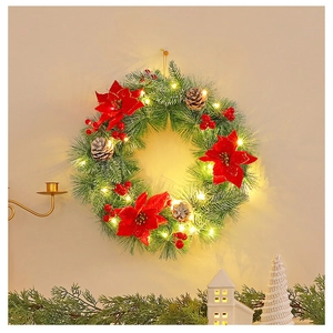 Detail of Christmas wreath with red poinsettias, pine cones, berries and warm LED lights