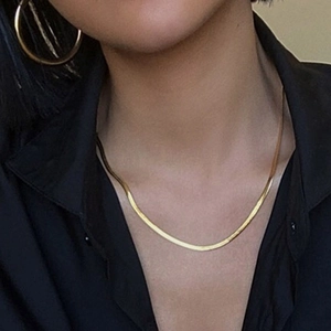 Elegant gold-plated stainless steel snake chain necklace and large hoop earrings on model