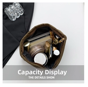 Top view of brown quilted floral bag showing large interior capacity with makeup items